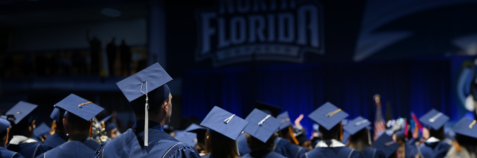 rows of students at commencement from behind