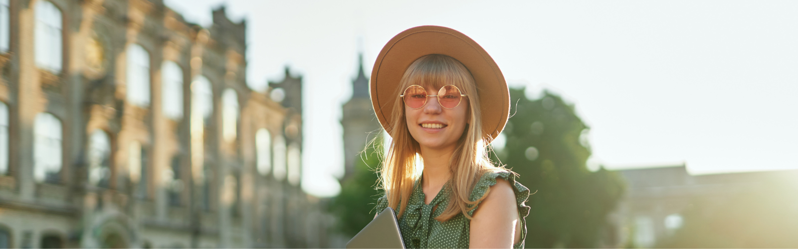 Women wearing a hat and sunglasses in a foreign country