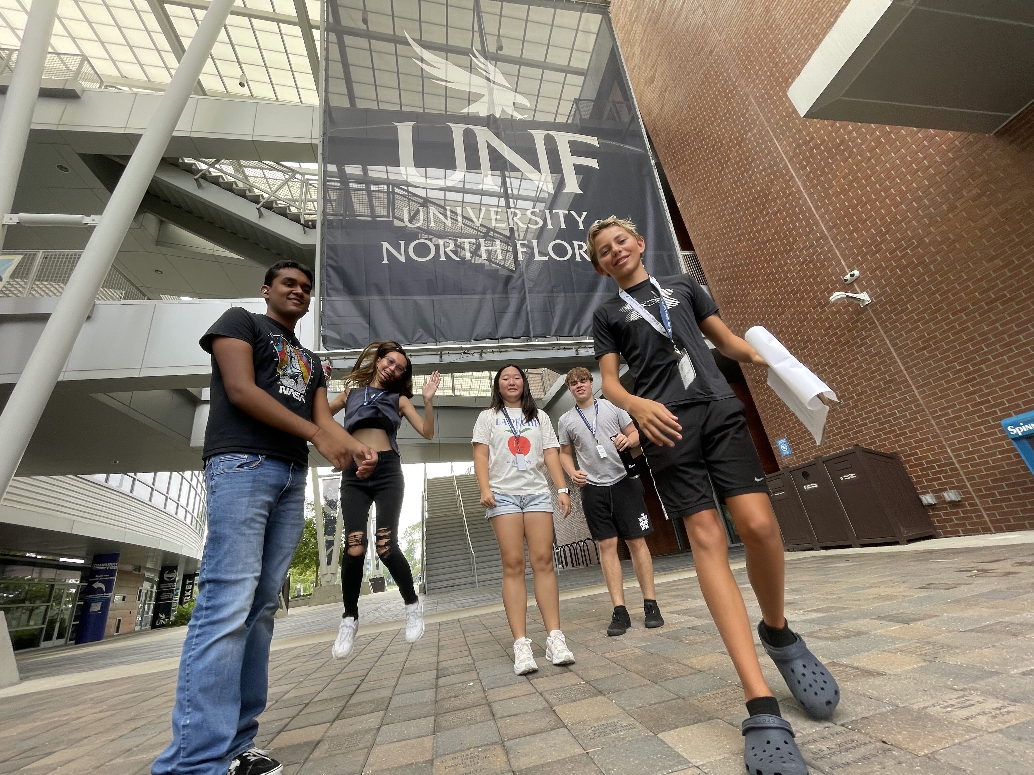 Ethic Academy campers in front of UNF sign at the student union
