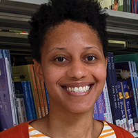 Imani Phillips in front of books