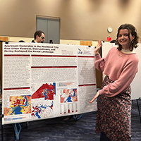 Katelyn Renzi standing in front of poster at conference