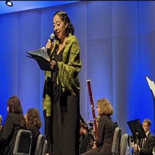 Woman singing in front of orchestra