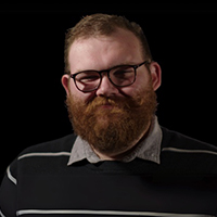 Andrew Pemberton in front of black background