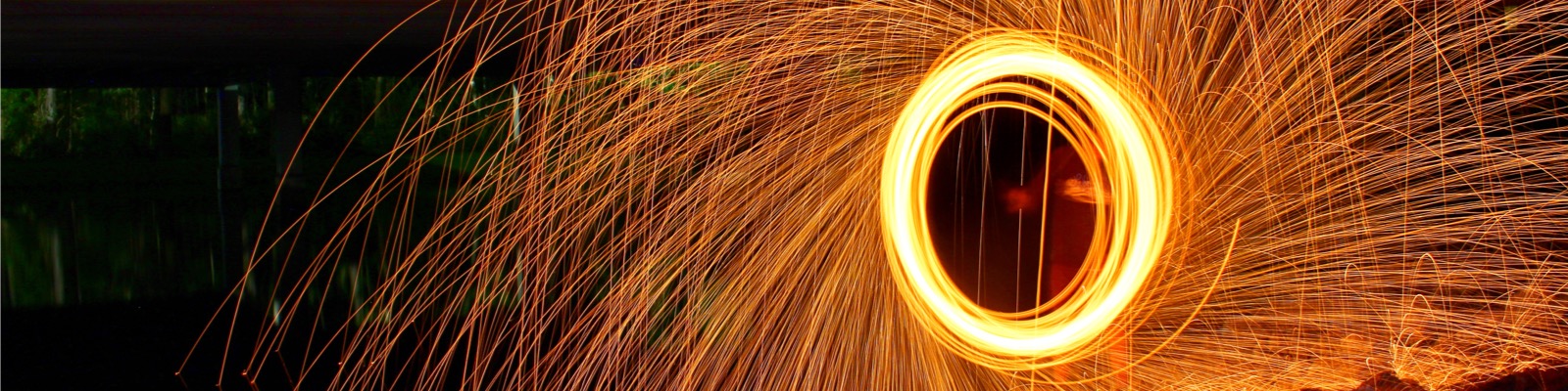 Circular blaze of sparks at night