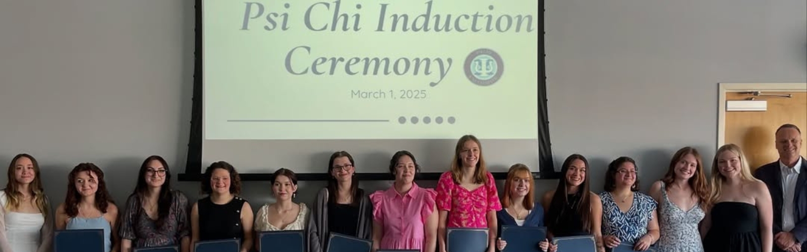 A group of students being inducted into Psi Chi