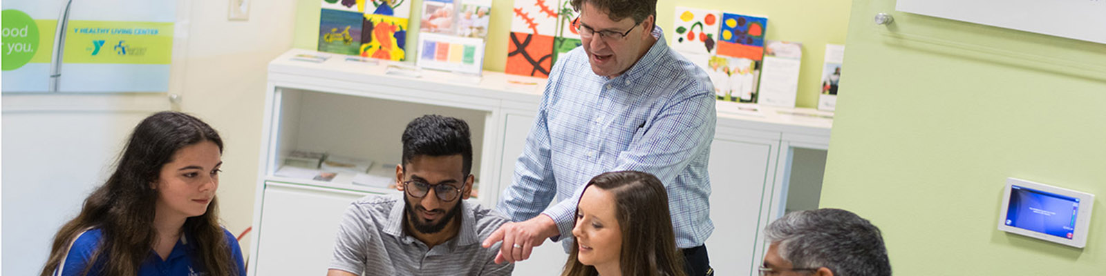 students and teachers discussing a research topic together in a classroom