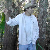Keith Ashley standing in front of trees