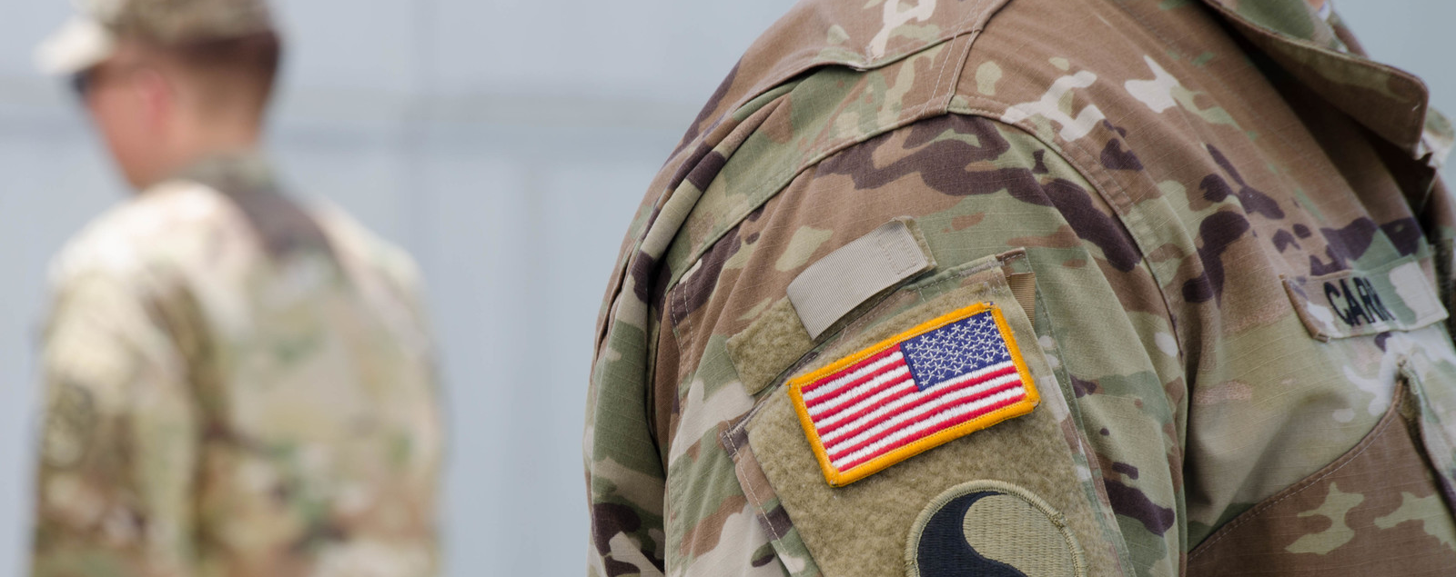 American flag patch on the shoulder of a guy wearing an Army uniform