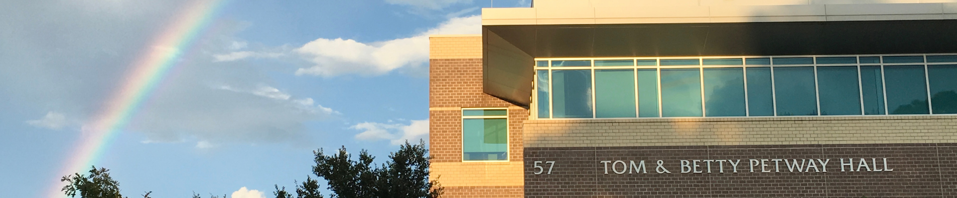 Tom and Betty Petway Hall exterior with a rainbow