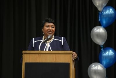 Dr. Diana Greene standing behind a podium speaking