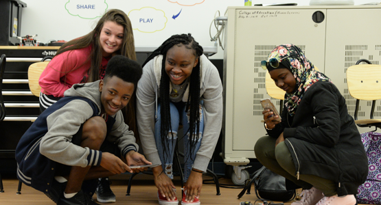 Group of students in the STEP Lab playing with equipment