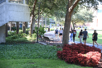 A tour group on UNF's campus following the guide