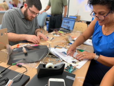 Two adults working on a project in the Step Lab