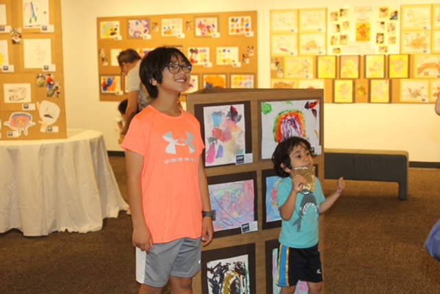 Two boys looking at art at the UNF Art Gallery