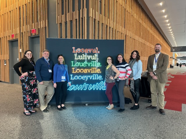 Group photo of SPIDERS members at an event in Louisville