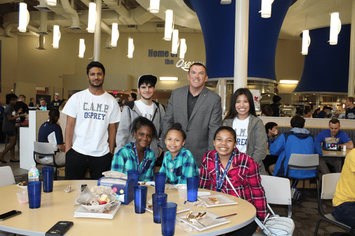 group of people smiling at a table