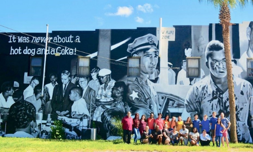 hope and history mural with UNF group and students infront 