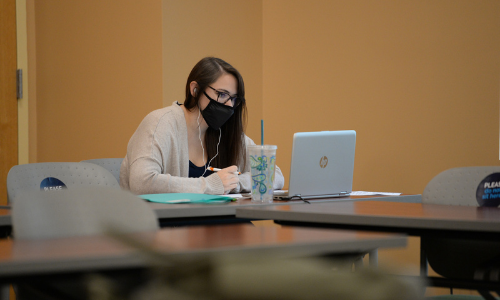 student in class on laptop