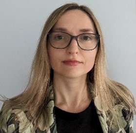 Headshot of Alona Bilokha with a light gray background 