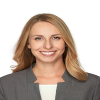 Head shot of Dr. Rhiannon smiling, with a white background. 
