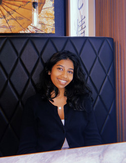 Young woman smiling in front of black background