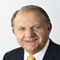 A Headshot of David Jaeger smiling and wearing a suit.