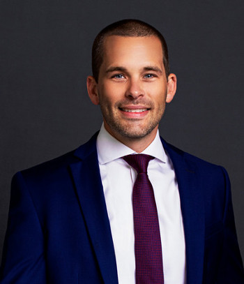 Headshot of Chris Kalin with a gray and white background