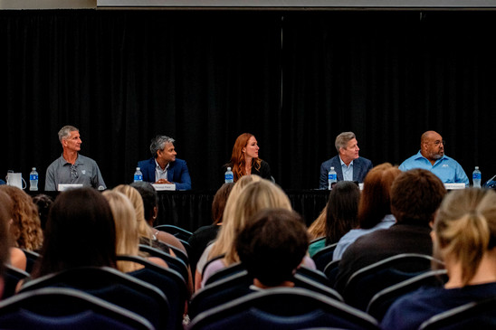 foundation of business panel members and crowd of seatedstudents 