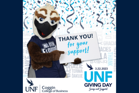 Ozzie holding up Thank You for your support 3.22.23 UNF GIVING DAY Swoop and Support UNF Coggin College of Business