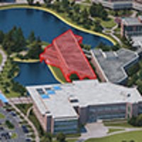 A aerial image that consists of 3 UNF buildings and a river with one highlighted red