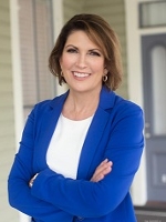 Headshot of Karen Bowling wearing dark blue blazer, white shirt and earrings