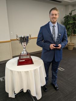 Osprey Financial Group winner holding an award next to a trophy