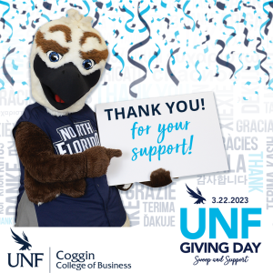 Ozzie holding up Thank You for your support 3.22.23 UNF GIVING DAY Swoop and Support UNF Coggin College of Business