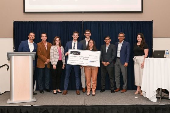 CEI Innovation Week Winner; group of students holding a check