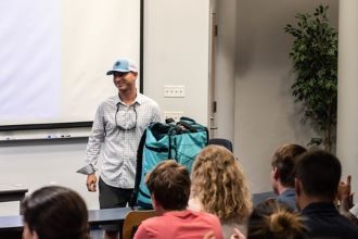 Steve Elder talking to a group of students