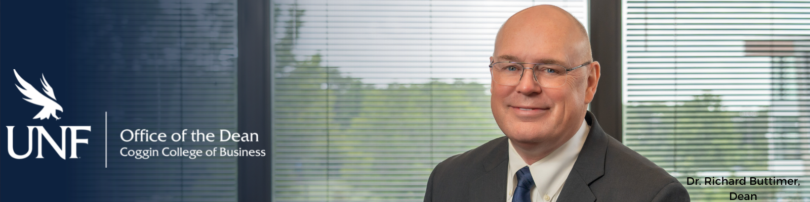 UNF logo with osprey logo and office of the dean Coggin college of business with blue gradient, headshot of the dean at his desk, dr. richard buttimer, dean