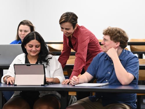 nilufer helping students in a classroom