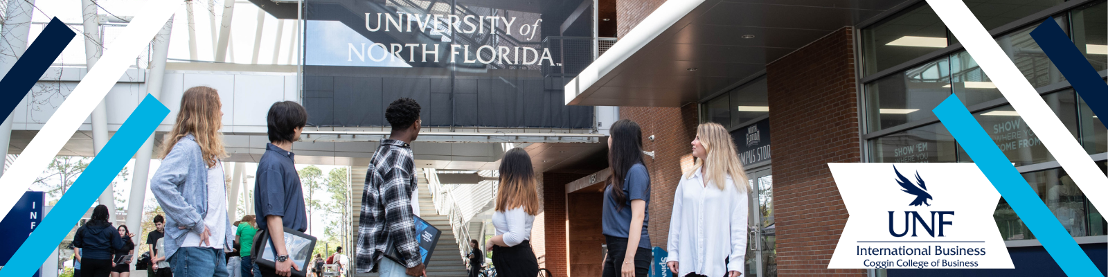 6 international business students standing next to a blue metal UNF sign with international business logo in blue in the bottom right corner 