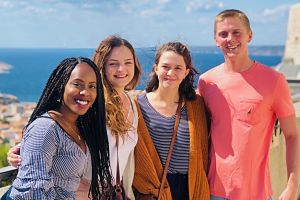 Group of four students smiling