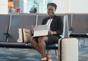 Photo of mansenie smiling while sitting down with laptop