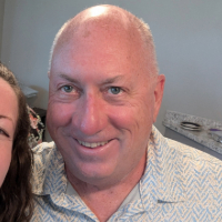 Portrait image of Jeff steagall smiling. It is a cropped image, where jeff is taking the picture with another person. 