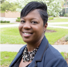 joslyn simmons2 (2) headshot of jennifer jackson wearing a beaded necklace and blazer with unf campus in background