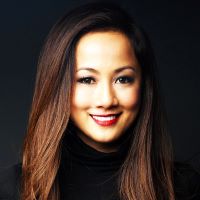 Headshot of Czarah Cabrera wearing black turtleneck with black background