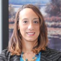 Headshot of Elexia Coleman wearing striped blazer with blue shirt