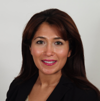 Headshot of Reham with black blazer and grey background