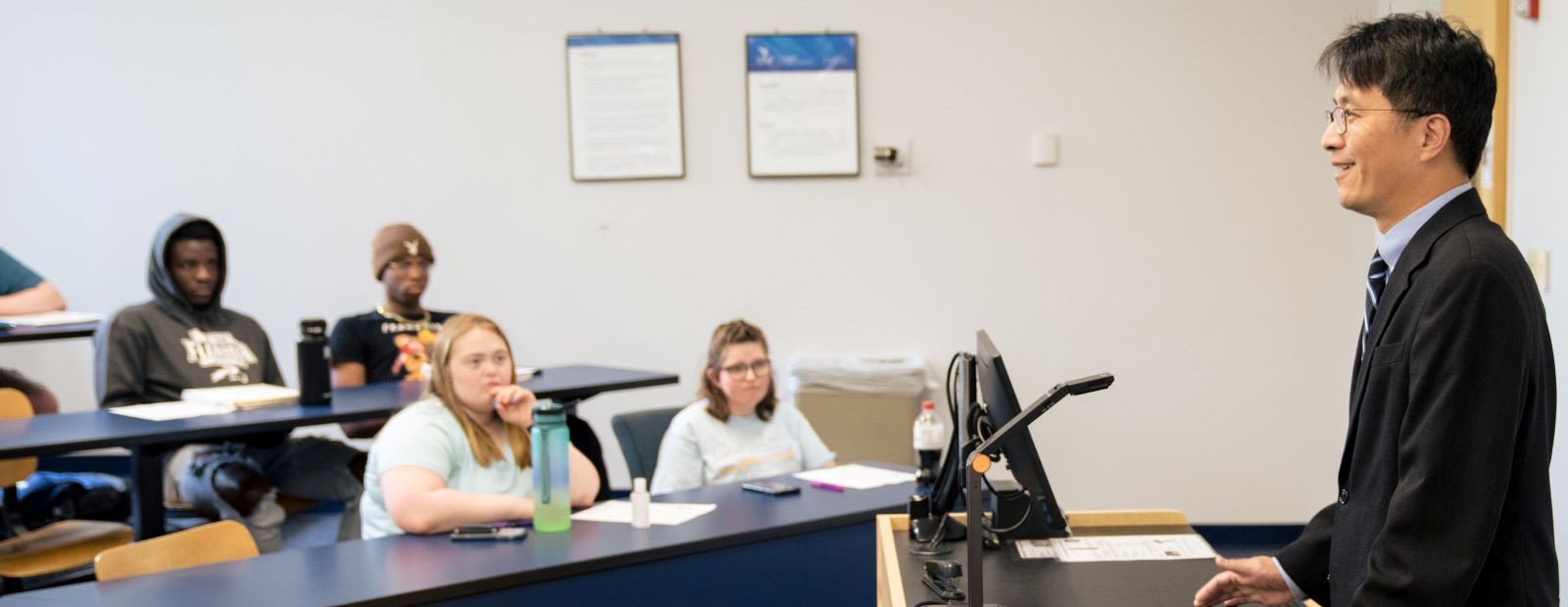 Dr. Albert Loh in front of class with students