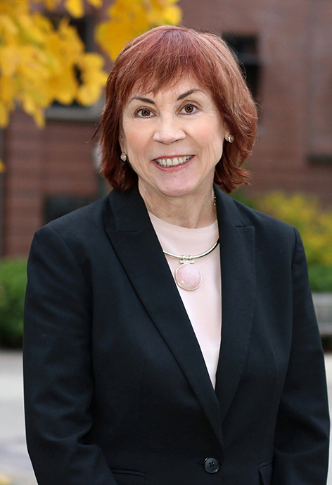 Woman in black suite with red hair
