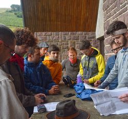 Group of students around a table looking at paper