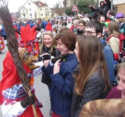 Students laughing at a person in costume
