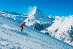 Downhill skier in snowy mountains